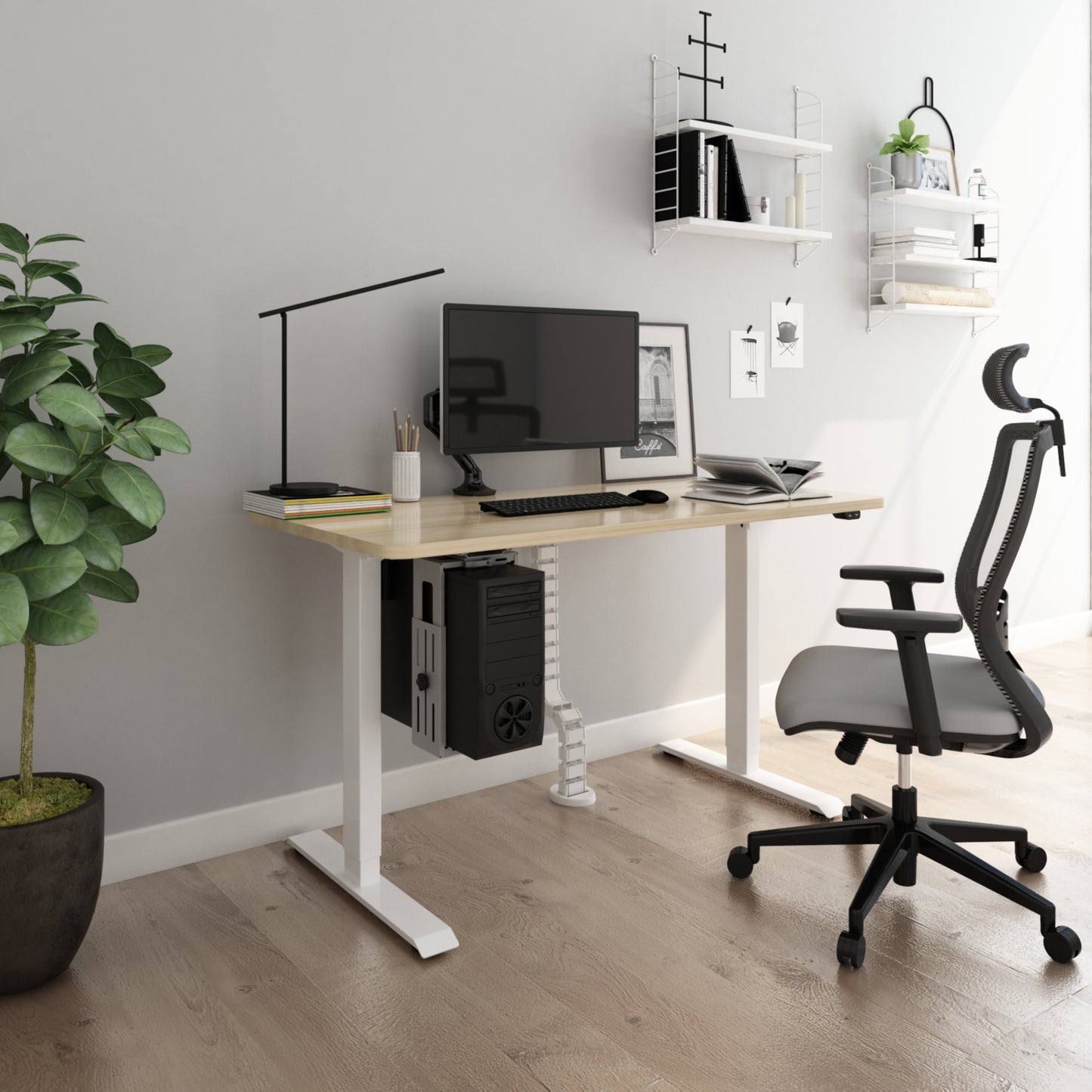 heritage height adjustable table with beige table top and white frame illustrated in a home office with some plants and shelves
